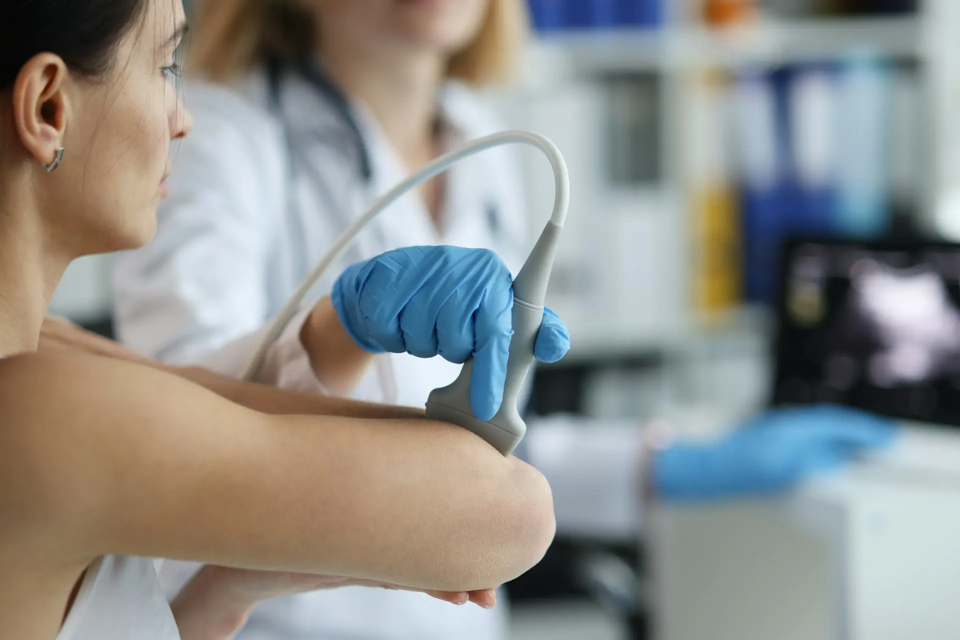 Healthcare professional assessing a patient’s back or shoulder area for inflammation-related pain.