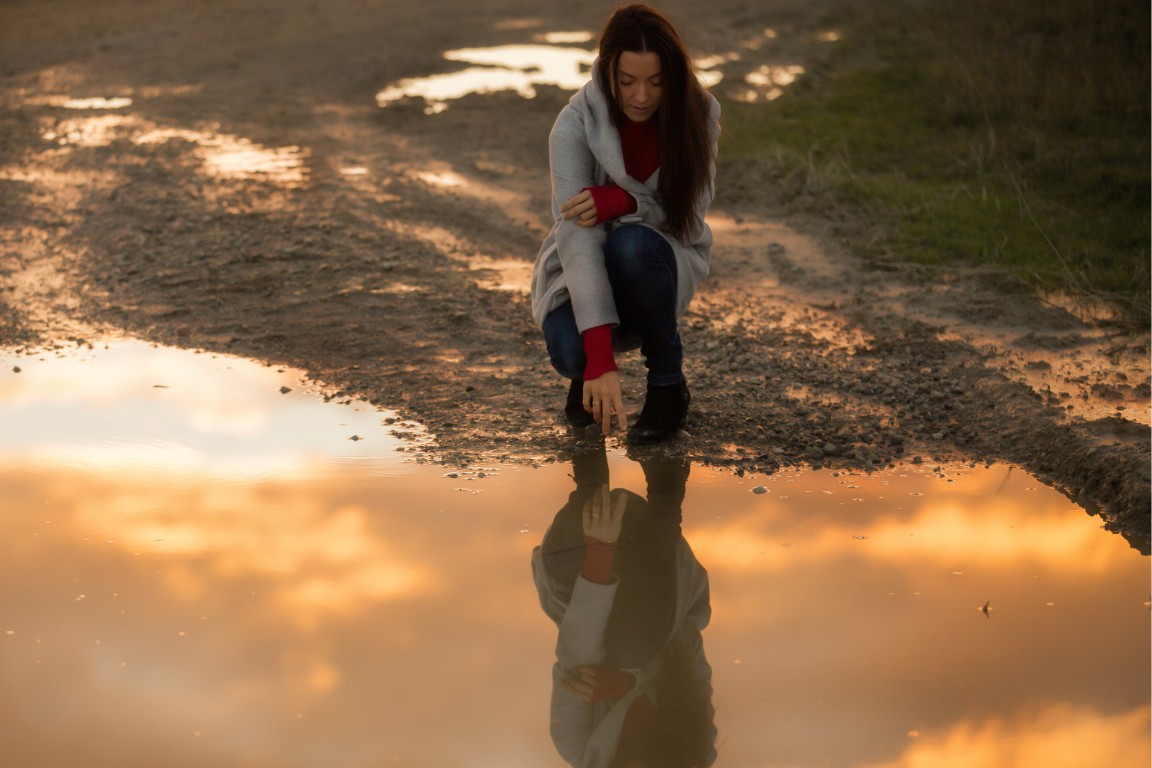 Woman looking at a reflection of herself