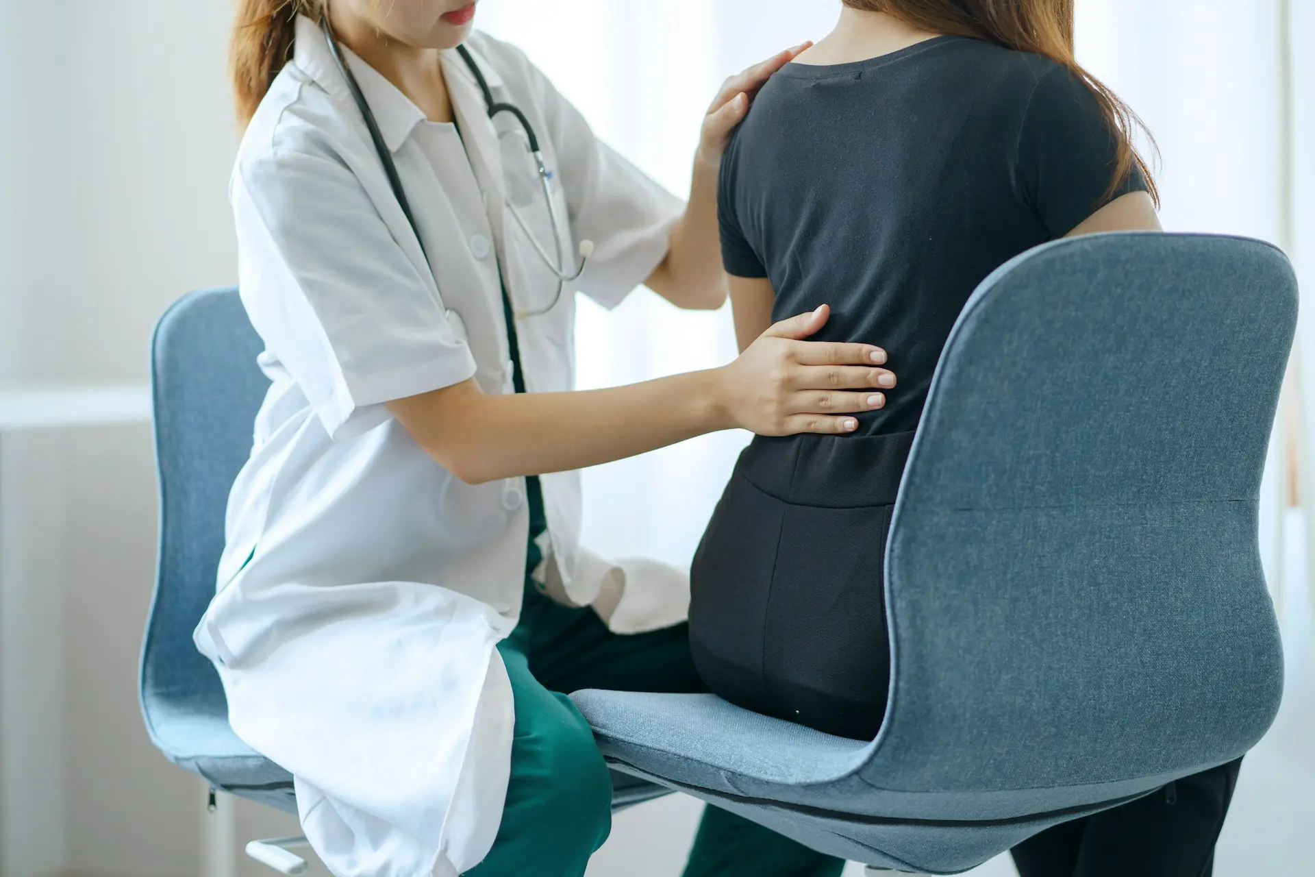 Clinician evaluating a patient’s back for nerve-related pain or dysfunction.