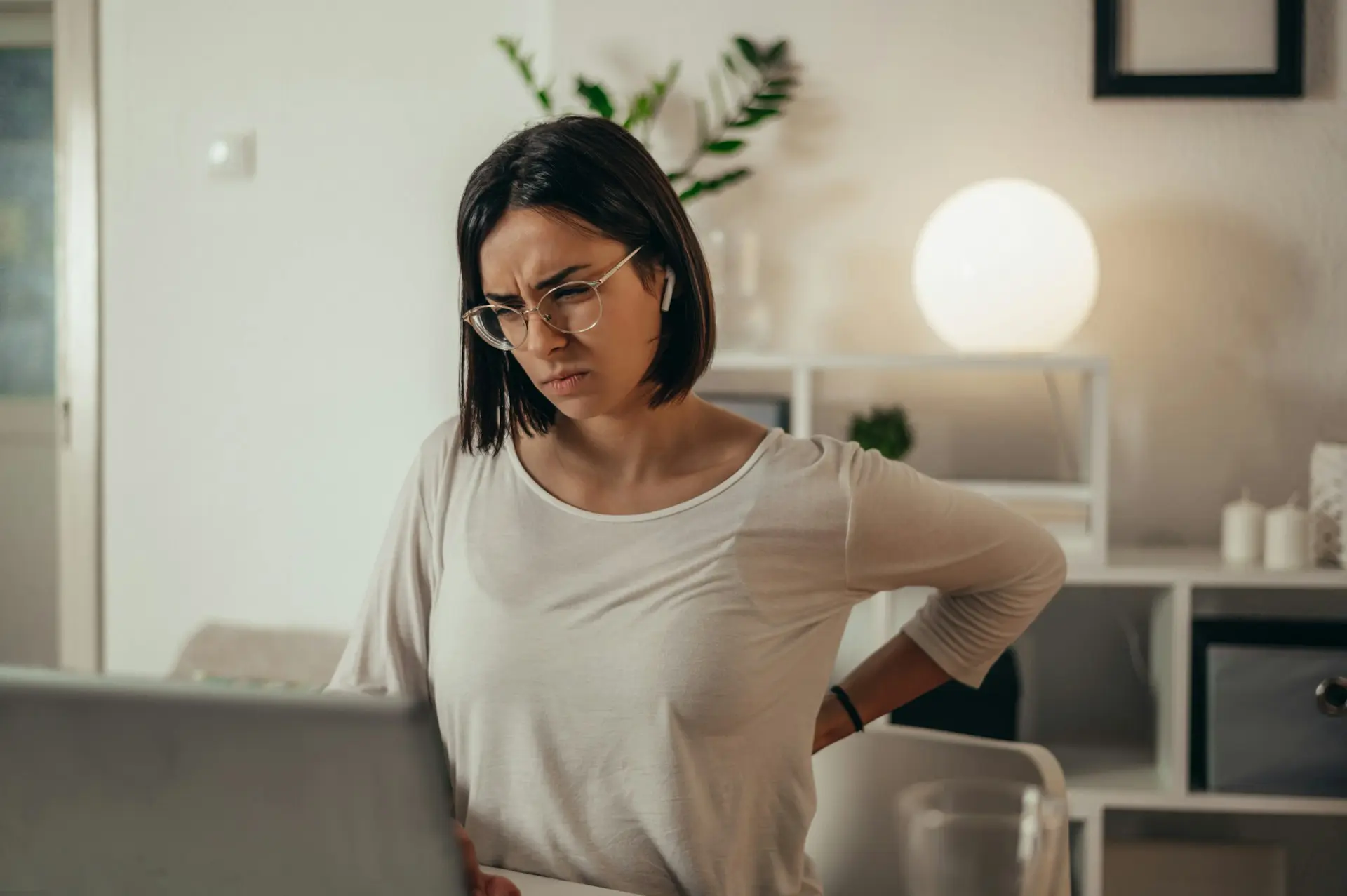 Woman experiencing hip discomfort while at her desk